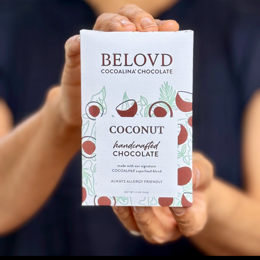 Hands holding Belovd Coconut Chocolate Bar in packaging
