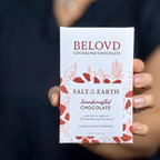 Hand holding Belovd Salt of the Earth Chocolate Bar 