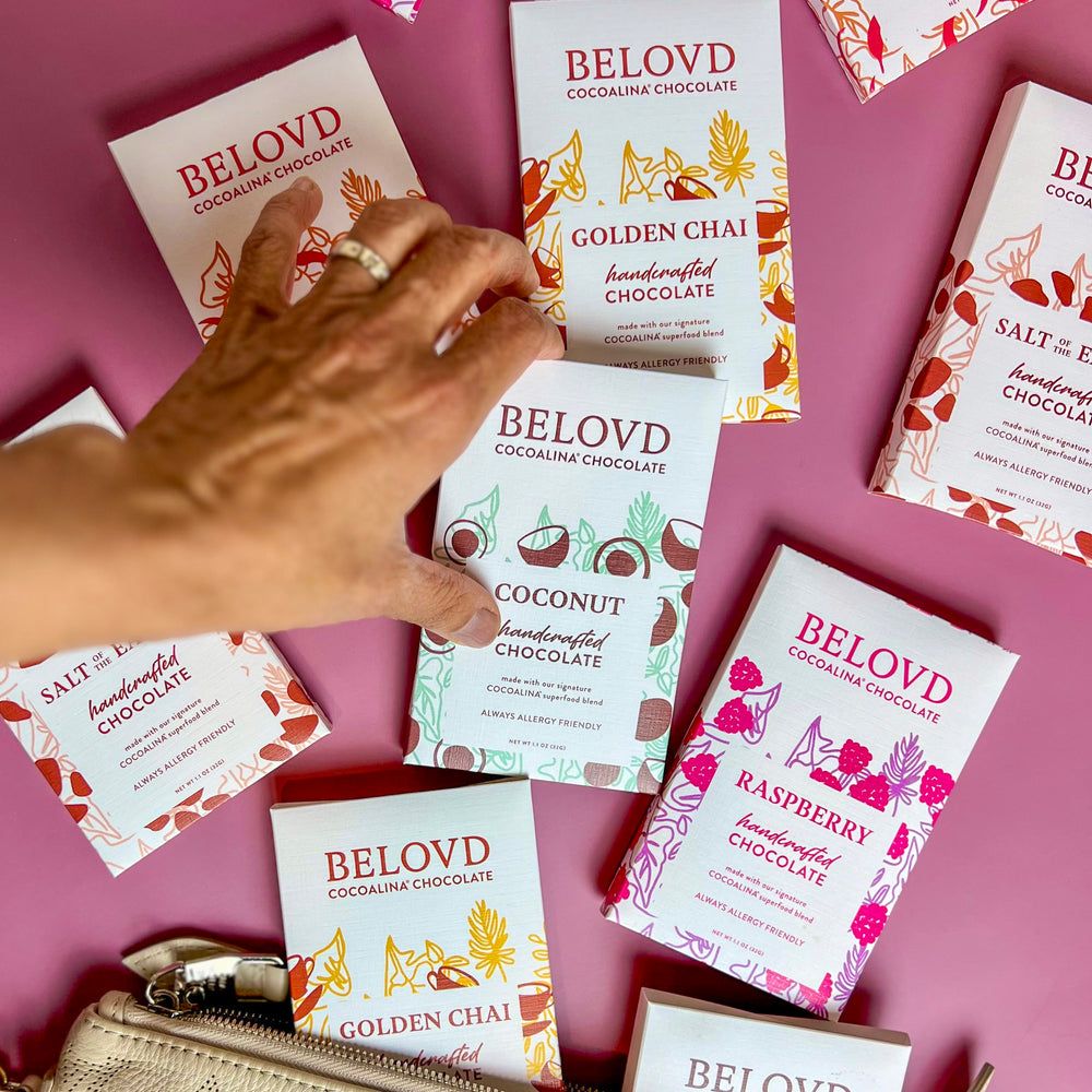 Hand selecting from an array of Belovd chocolate bars