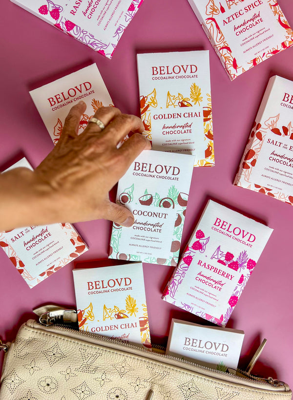 Hand selecting from an array of Belovd chocolate bars